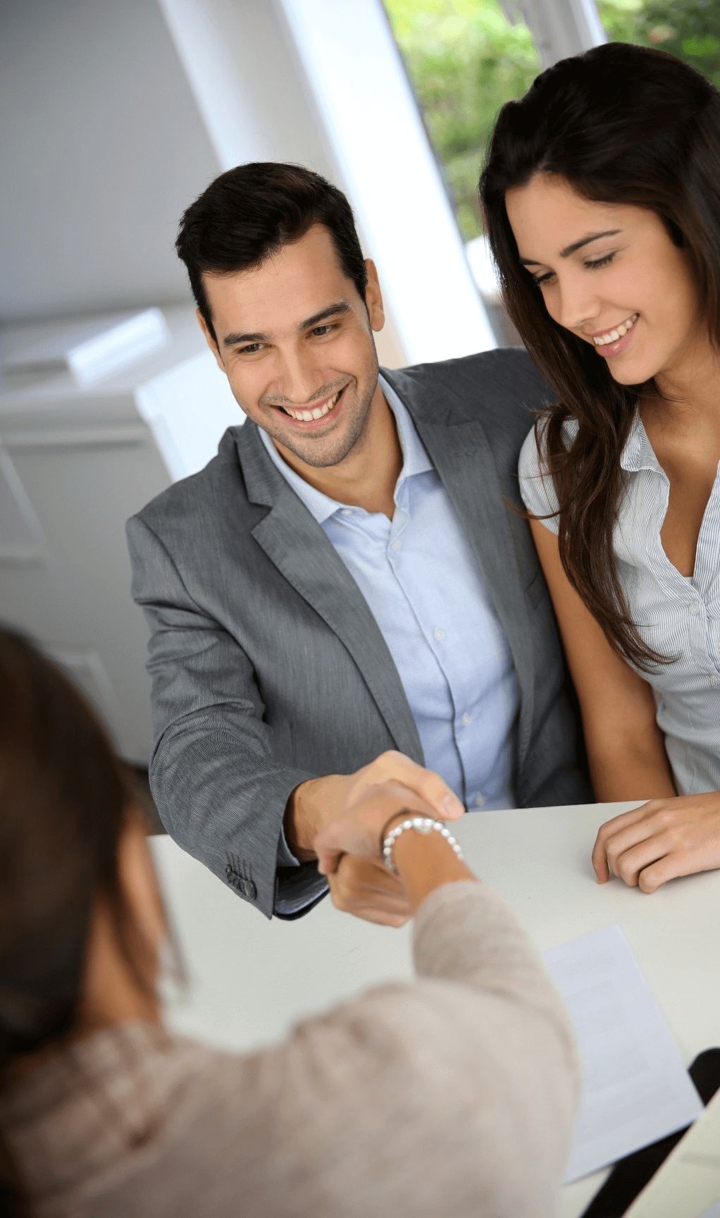 couple shaking hands to close a deal