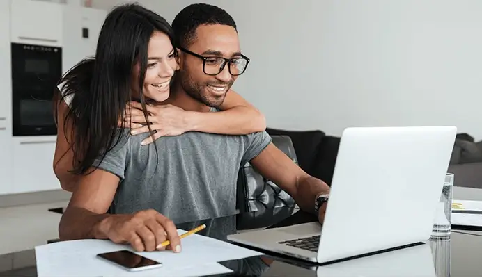 Happy couple cheering their successful new home purchase thanks to Prime Rate Mortgage ™